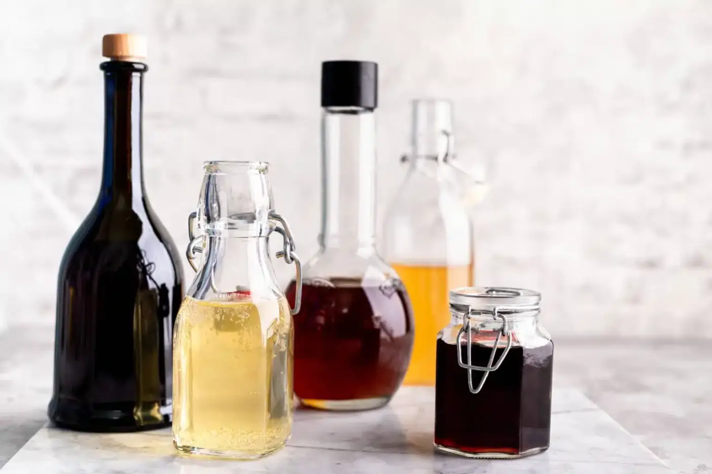 different types of vinegar in glass bottles