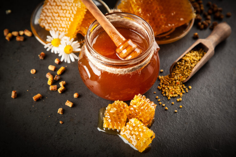 Honey jar and dipper with leaking honey